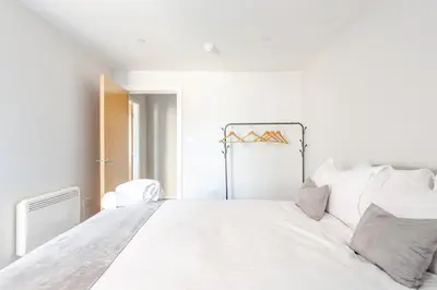 a white bedroom with a large white bed at Liverpool Nightlife Spot City Centre 1BD apartment and Sofa bed in Liverpool