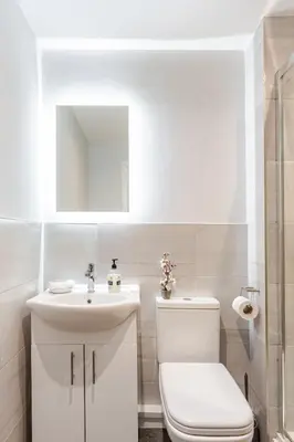 a white bathroom with a toilet and a sink at Liverpool Nightlife Spot City Centre 1BD apartment and Sofa bed in Liverpool