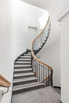 a spiral staircase in a white room with a stair case at Liverpool Nightlife Spot City Centre 1BD apartment and Sofa bed in Liverpool