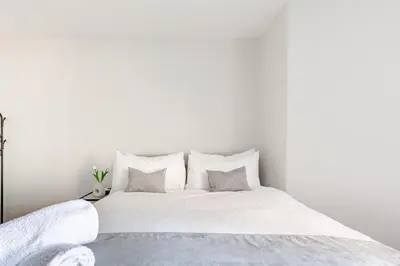 a white bed with white sheets and pillows at Liverpool Nightlife Spot City Centre 1BD apartment and Sofa bed in Liverpool