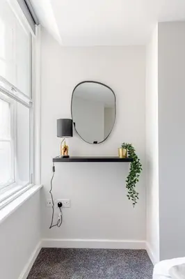 a mirror on a shelf in a white room with a window at Liverpool Nightlife Spot City Centre 1BD apartment and Sofa bed in Liverpool