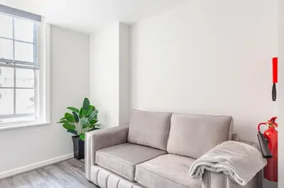 a living room with a couch and a window at Liverpool Nightlife Spot City Centre 1BD apartment and Sofa bed in Liverpool