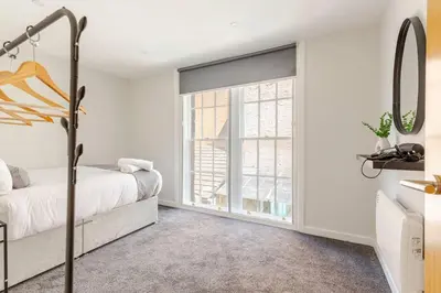 a bedroom with a bed and a window at Bright 1-Bed Apartment In City Centre Liverpool in Liverpool