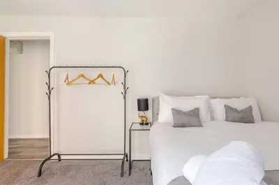 a white bedroom with a bed and a mirror at Bright 1-Bed Apartment In City Centre Liverpool in Liverpool