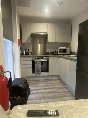 a kitchen with white cabinets and a stove top oven at City Comfort Modern 1-Bed Apartment sleeps up to 4 in Liverpool