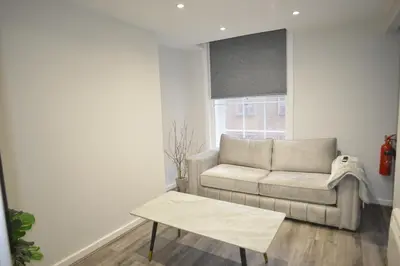 a living room with a couch and a table at City Comfort Modern 1-Bed Apartment sleeps up to 4 in Liverpool