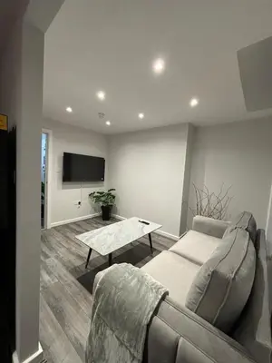 a living room with a couch and a table at City Comfort Modern 1-Bed Apartment sleeps up to 4 in Liverpool