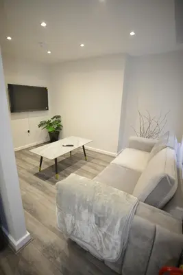 a living room with a couch and a table at City Comfort Modern 1-Bed Apartment sleeps up to 4 in Liverpool