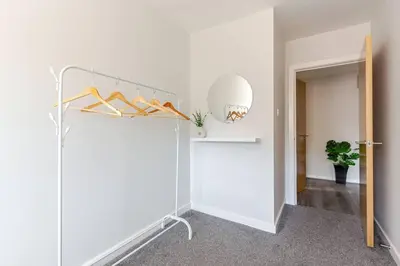 a walk in closet with a white wall at Liverpool City Stay 1-Bed apartment with 2 Sofa Beds, Sleeps up to 6 in Liverpool