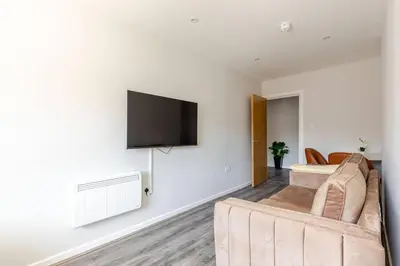 a living room with a couch and a tv on a wall at Liverpool City Stay 1-Bed apartment with 2 Sofa Beds, Sleeps up to 6 in Liverpool