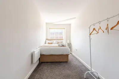 a white bedroom with a bed and a window at Liverpool City Stay 1-Bed apartment with 2 Sofa Beds, Sleeps up to 6 in Liverpool
