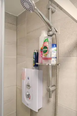 a bathroom with a shower with a shower head at Liverpool City Stay 1-Bed apartment with 2 Sofa Beds, Sleeps up to 6 in Liverpool