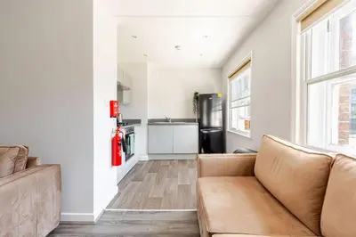 a living room with a couch and a kitchen at Liverpool City Stay 1-Bed apartment with 2 Sofa Beds, Sleeps up to 6 in Liverpool
