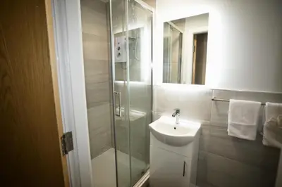 a bathroom with a sink and a glass shower at Walk to City Hotspots Liverpool 1BD Apartment in Liverpool
