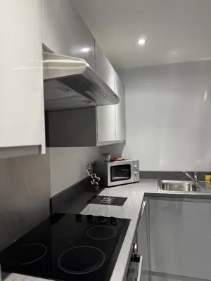 a kitchen with a black stove and a microwave at Walk to City Hotspots Liverpool 1BD Apartment in Liverpool