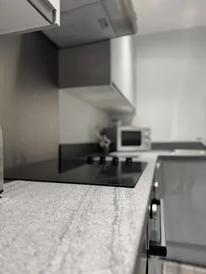 a kitchen with a black and white counter top at Walk to City Hotspots Liverpool 1BD Apartment in Liverpool