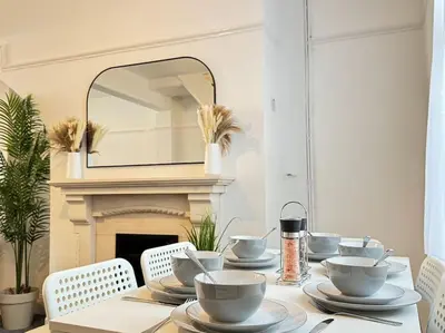 a table with bowls and plates on it with a mirror at TV in Every Room Free Parking in Liverpool