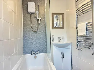 a bathroom with a tub and a sink and a bath tub at TV in Every Room Free Parking in Liverpool
