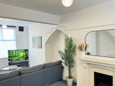 a living room with a couch and a television at TV in Every Room Free Parking in Liverpool