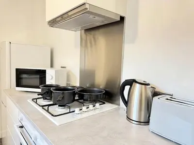 a kitchen with a stove with pots and pans on it at TV in Every Room Free Parking in Liverpool