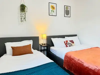 two beds sitting next to each other in a bedroom at Contractors and Groups with Parking in Liverpool