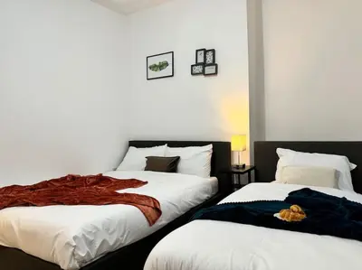 two beds sitting next to each other in a bedroom at Contractors and Groups with Parking in Liverpool