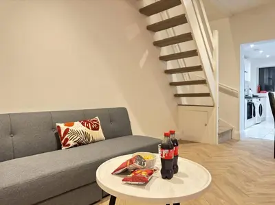 a living room with a couch and a table with drinks at Contractors and Groups with Parking in Liverpool