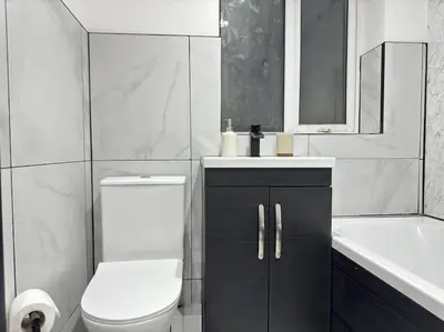 a white bathroom with a toilet and a sink at Contractors and Groups with Parking in Liverpool