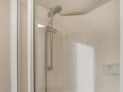 a shower with a shower head in a bathroom at Stay And Sea in Heysham
