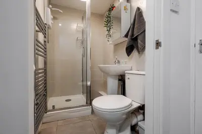 a bathroom with a toilet and a sink and a shower at LFC theme - free parking - 2 bathroom in Liverpool