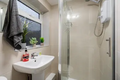 a bathroom with a sink and a shower at LFC theme - free parking - 2 bathroom in Liverpool