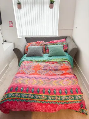 a bed with two pillows on it in a bedroom at LFC theme - free parking - 2 bathroom in Liverpool