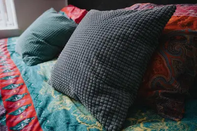 a bed with several pillows on top of it at LFC theme - free parking - 2 bathroom in Liverpool