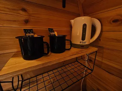 two coffee mugs sitting on a wooden shelf at The Laurels - Wood Fired Hot Tub and Firepit in Poulton le Fylde