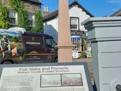 a sign in front of a pole with a building at Sunny Bank, Cark-in-Cartmel in Cark