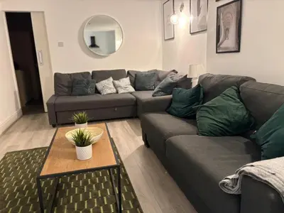 a living room with a couch and a table at Jude's Place 01 in Liverpool