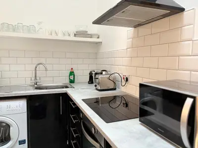 a kitchen with a sink and a dishwasher at Jude's Place 01 in Liverpool