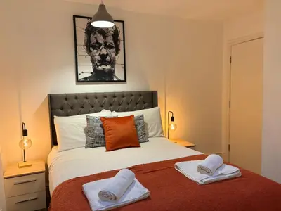 a bedroom with a bed with two towels on it at Jude's Place 01 in Liverpool