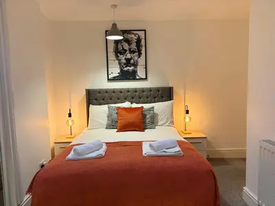 a bedroom with a bed with two towels on it at Jude's Place 01 in Liverpool