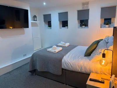 a bedroom with a bed with two towels on it at Jude's Place One Bedroom Apartments in Liverpool