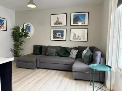 a living room with a couch and a table at Jude's Place One Bedroom Apartments in Liverpool
