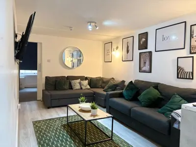 a living room with a couch and a table at Jude's Place in Liverpool