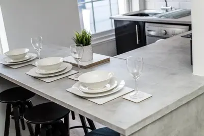 a table with plates and wine glasses on it at Jude's Place in Liverpool