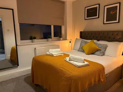 a bedroom with a bed with two towels on it at Jude's Place in Liverpool
