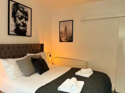 a bedroom with a bed with two towels on it at Jude's Place in Liverpool