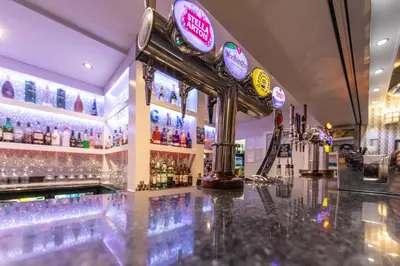 a bar with a lot of bottles of alcohol at Lyndene Hotel in Blackpool