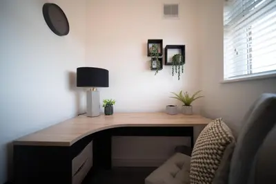 a wooden desk in a room with a chair at 20 Guest Luxury Stay - Private Pool, Hot Tub & Gym in Lytham St Annes