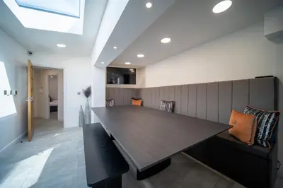 a dining room with a wooden table and chairs at 20 Guest Luxury Stay - Private Pool, Hot Tub & Gym in Lytham St Annes