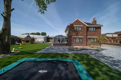 a house with a swimming pool in the yard at 20 Guest Luxury Stay - Private Pool, Hot Tub & Gym in Lytham St Annes