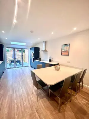 a kitchen and dining room with a table and chairs at Mode Cottage in Lytham St Annes